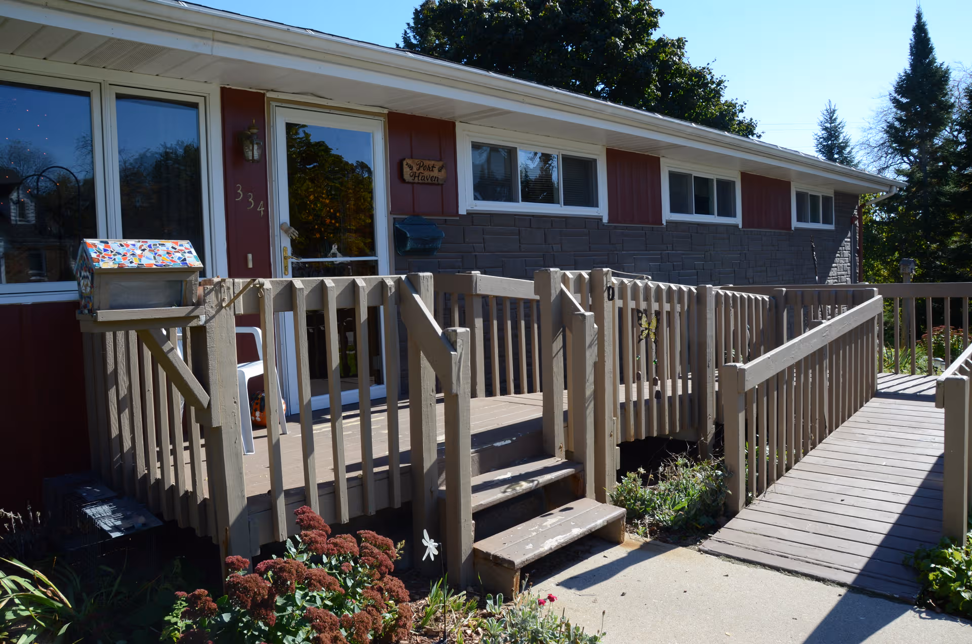 Exterior view of Port Haven senior facility with a wooden ramp and entrance.