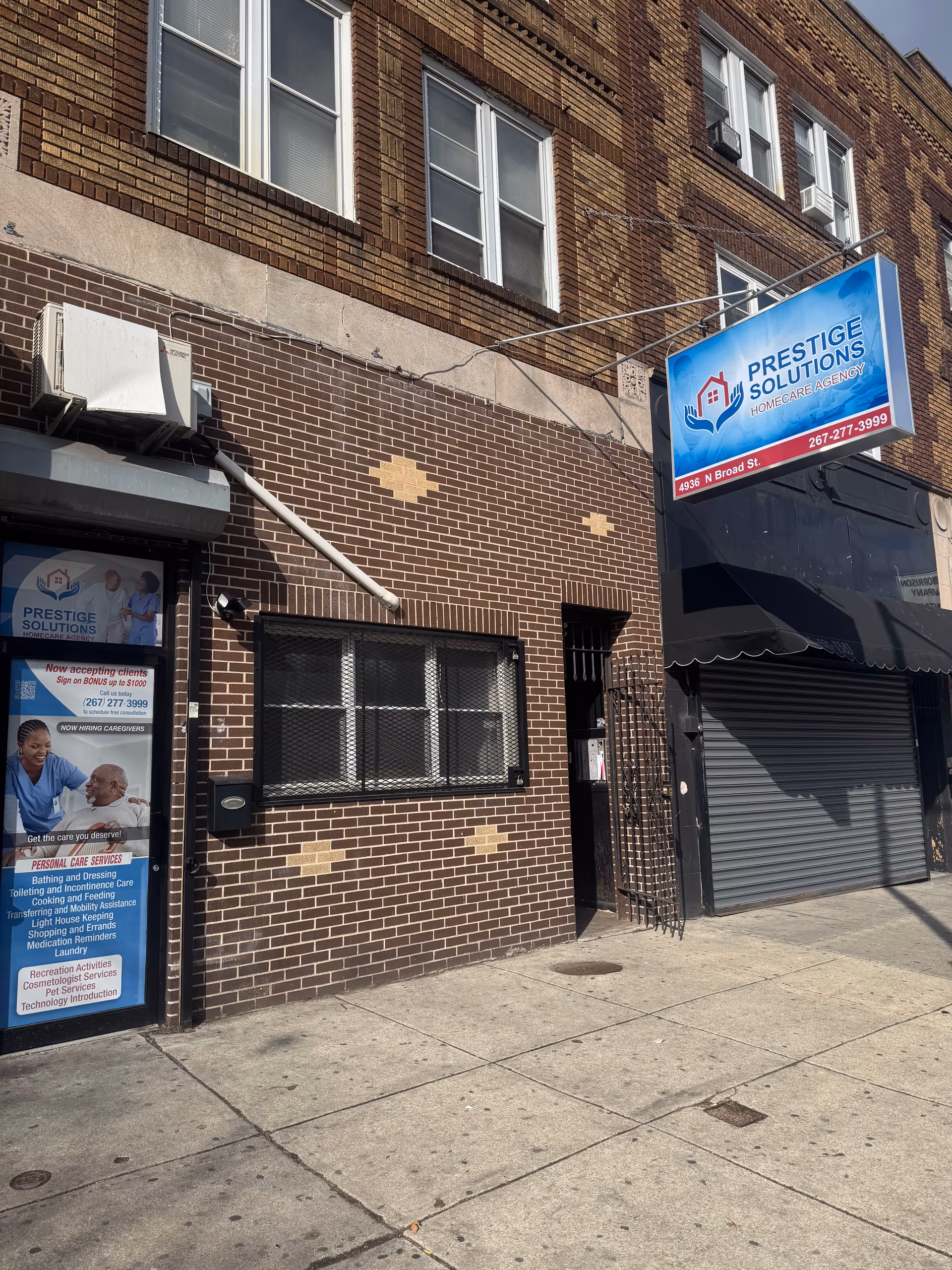 Brick building exterior with Prestige Solutions HomeCare Agency sign and storefront windows.