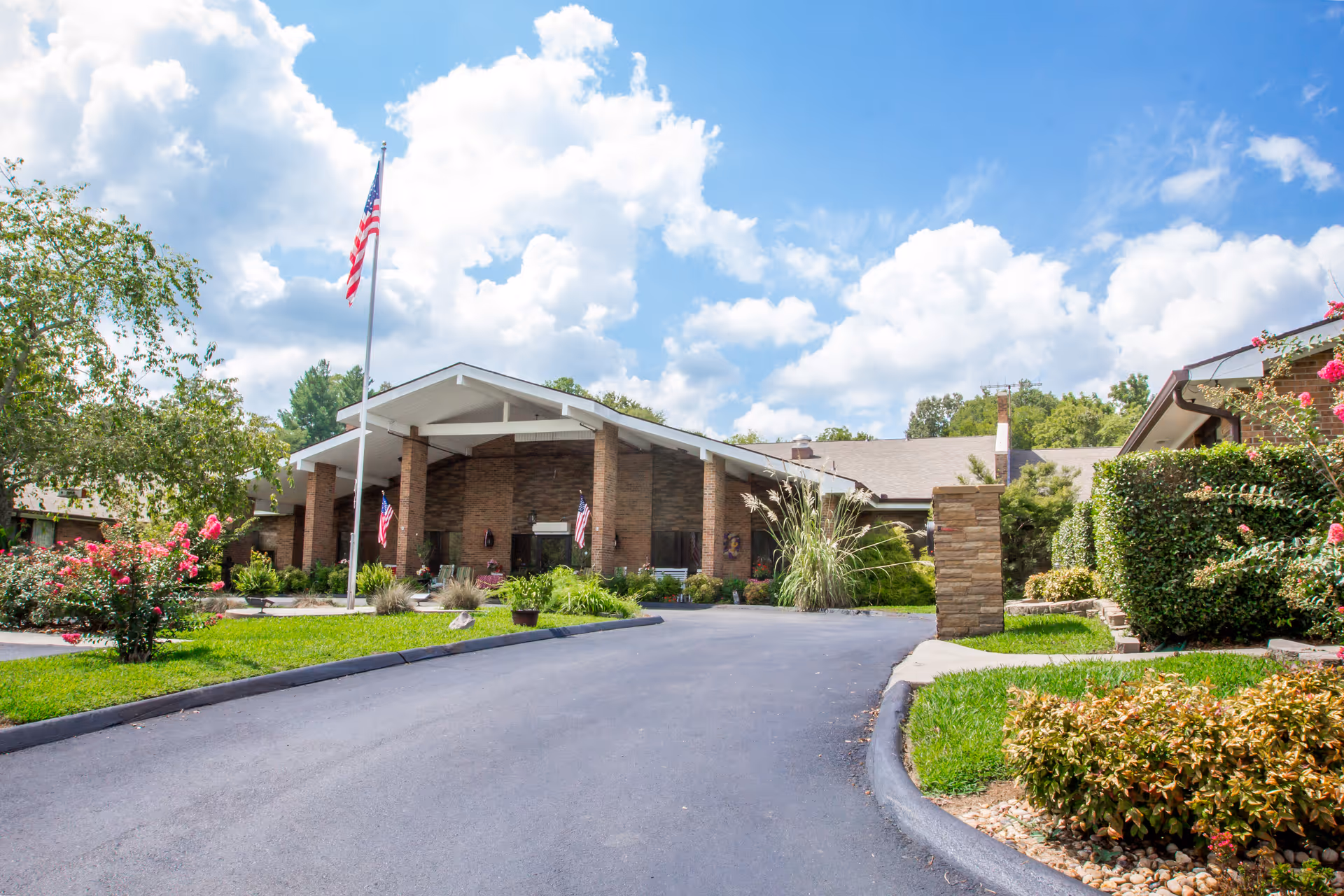 Exterior view of Signature Healthcare of Erin showing the entrance, flags, and landscaping.