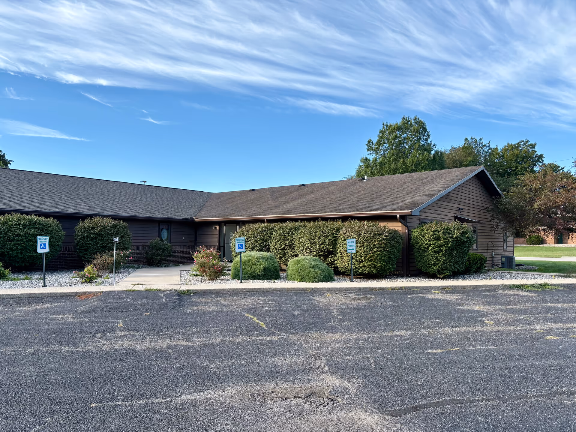 Exterior view of Servant's Heart Home Health Services building with parking and shrubs.