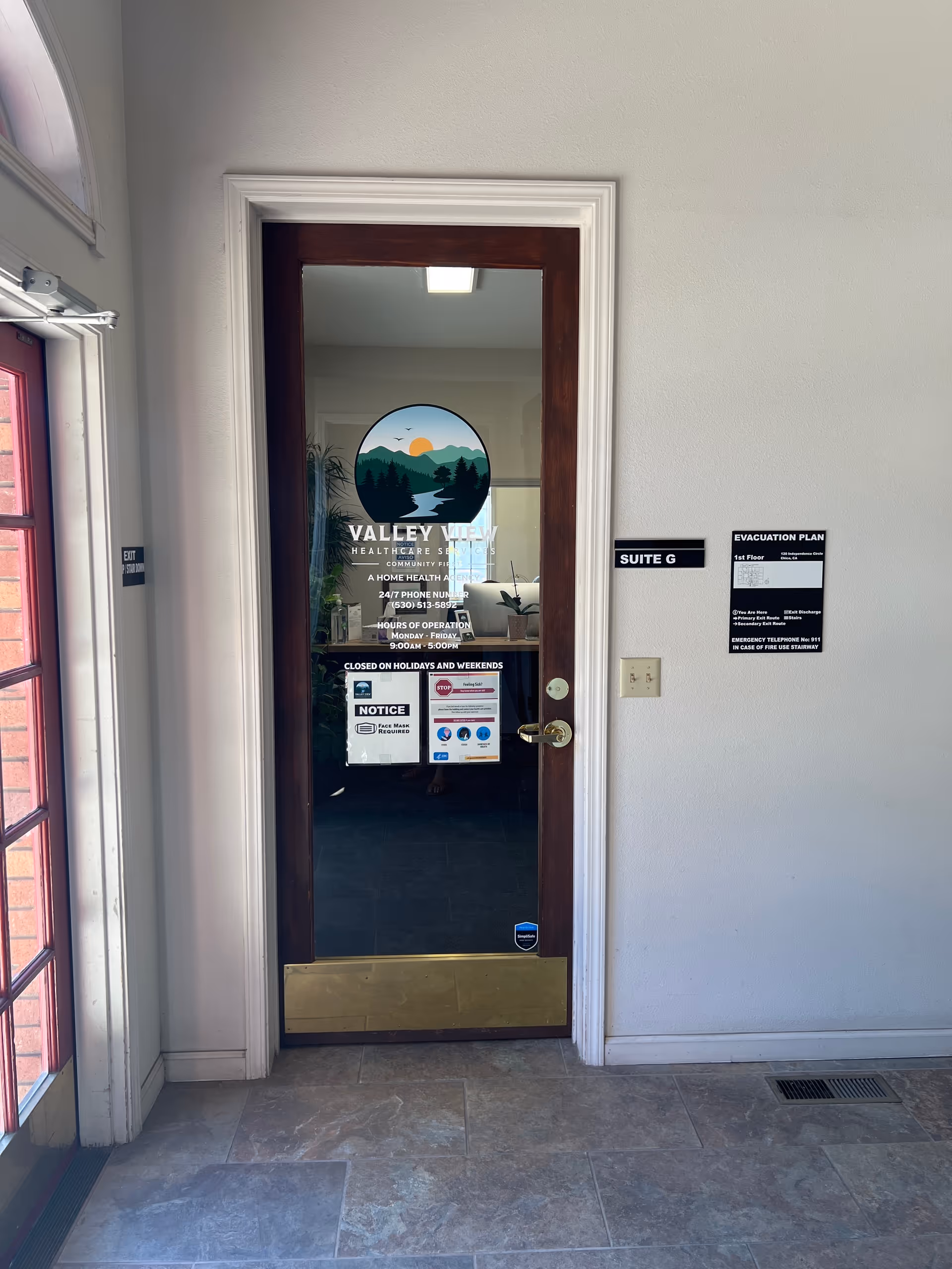 Interior door with Valley View Healthcare Services logo, suite sign, and evacuation plan.