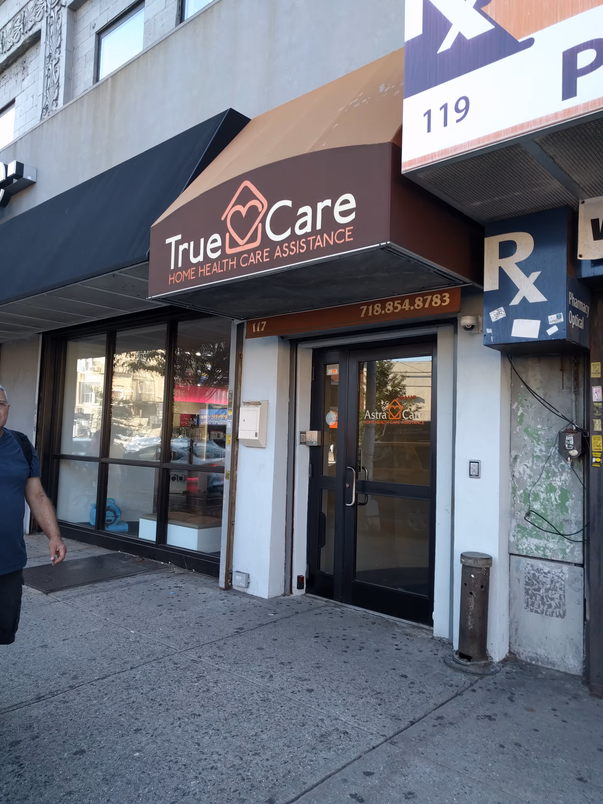 Exterior storefront signage for True Care Home Health Care Assistance with entrance and windows.