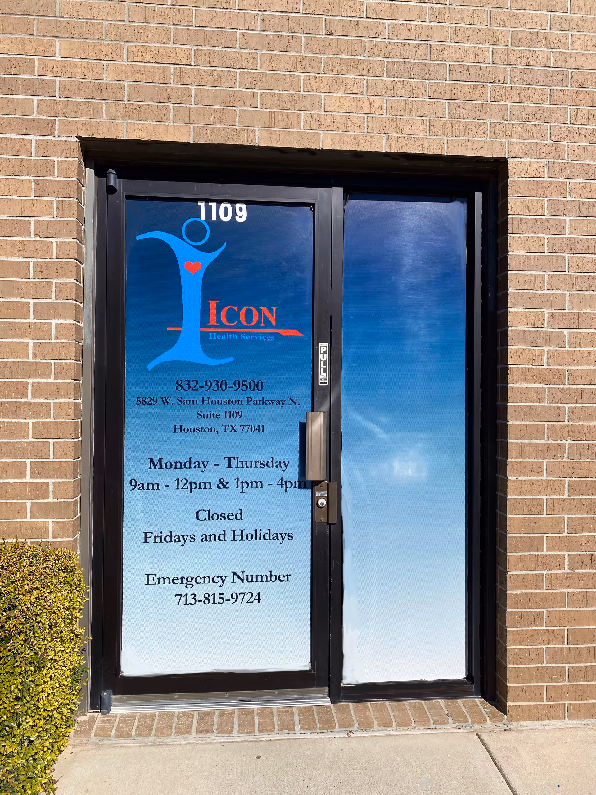 Blue gradient door with ICON Health Services logo on brick building exterior.
