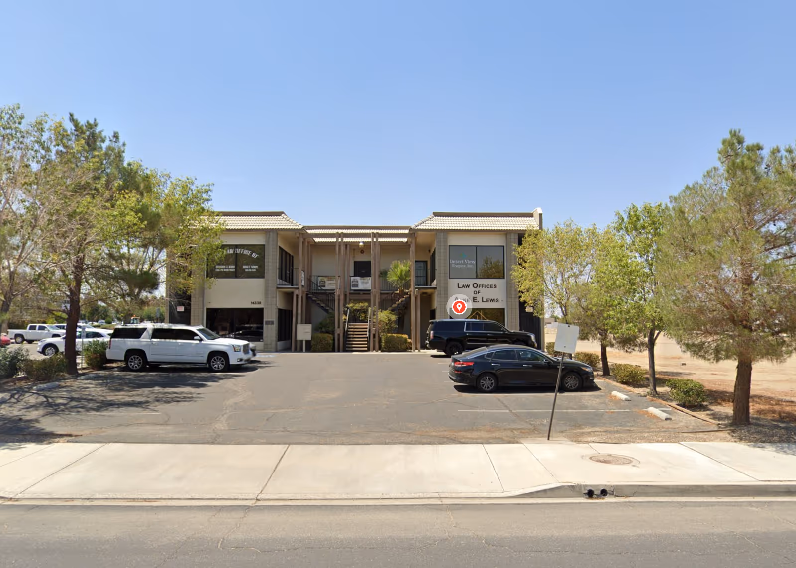 Exterior view of Desert View Hospice Inc. building with parked cars in front.