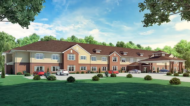 Exterior view of a two-story senior living facility with multiple parked cars.