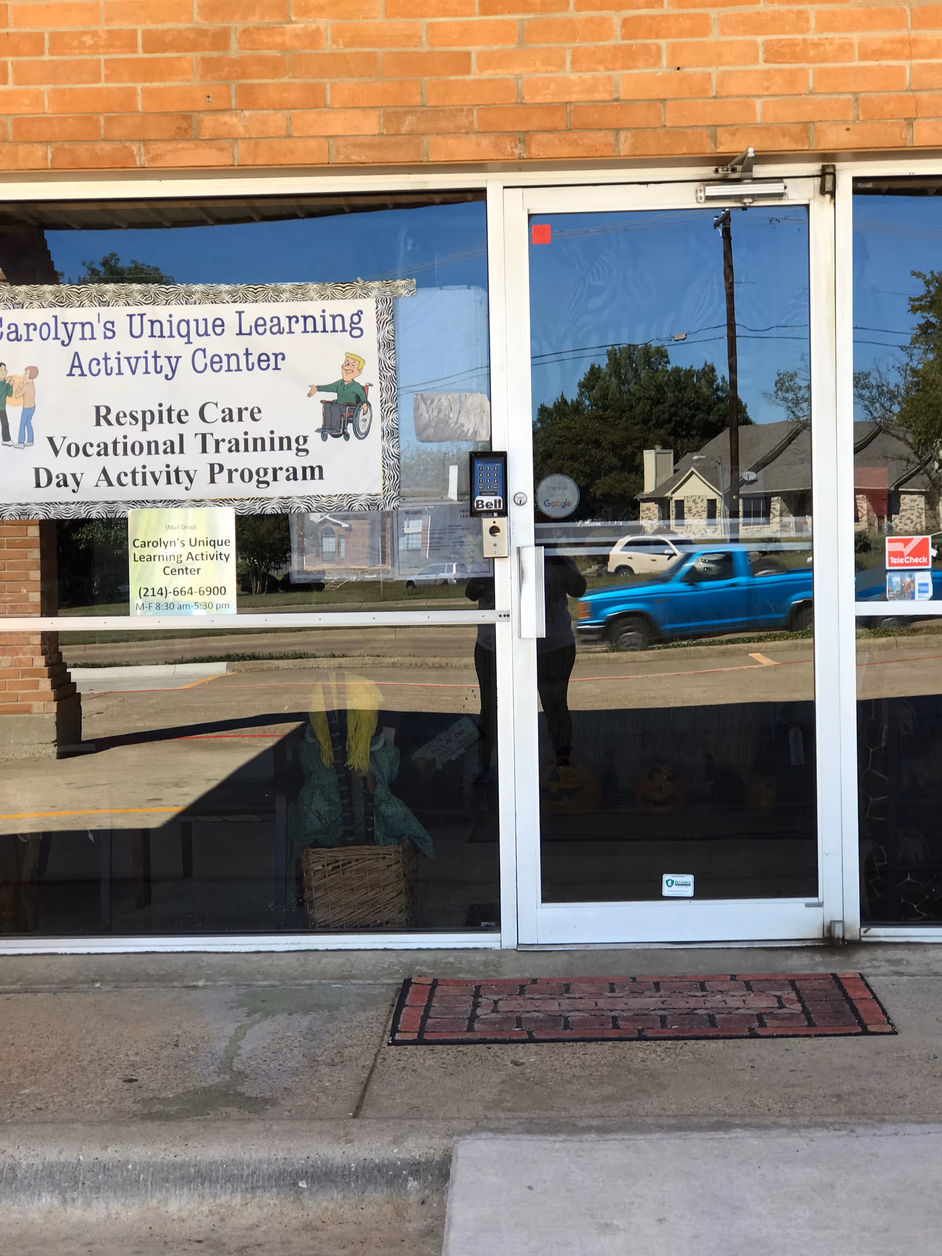 Glass storefront with banner reading Carolyn's Unique Learning Activity Center and program details.