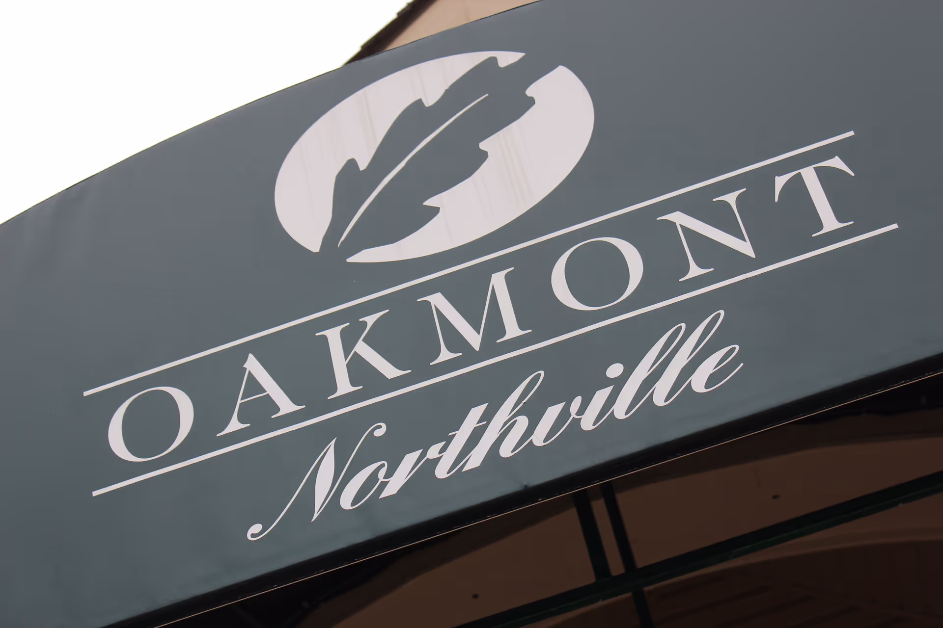 Close-up of the Oakmont Northville sign on the facility exterior.