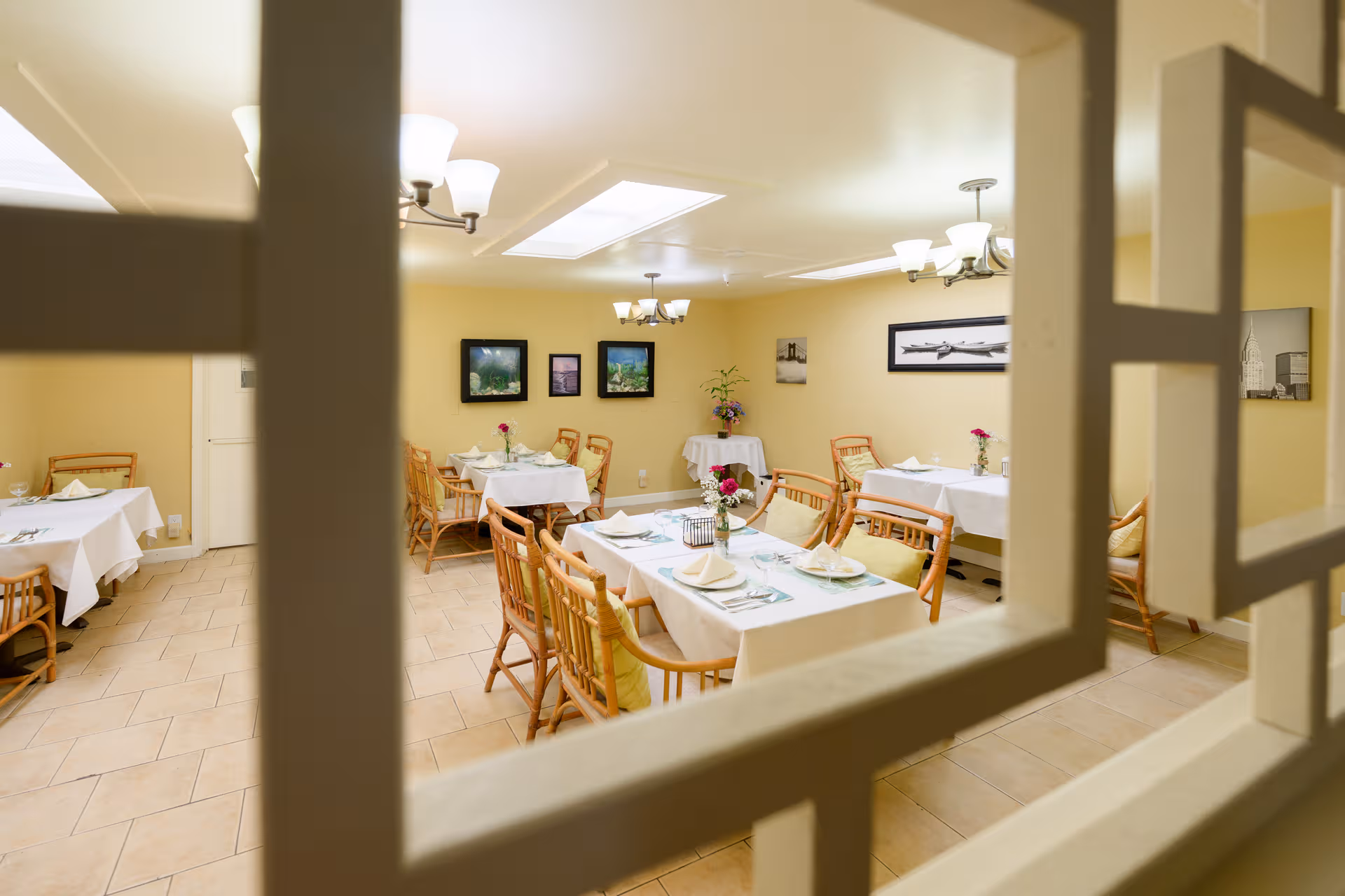 Maple House II dining room with tables set for meals and decor.