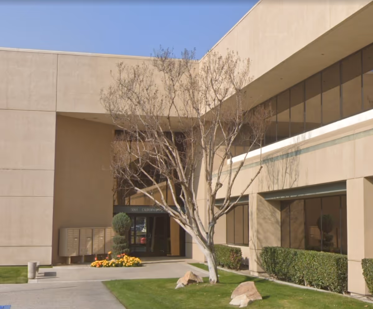 Exterior view of Allied Home Care facility entrance with trees and landscaping