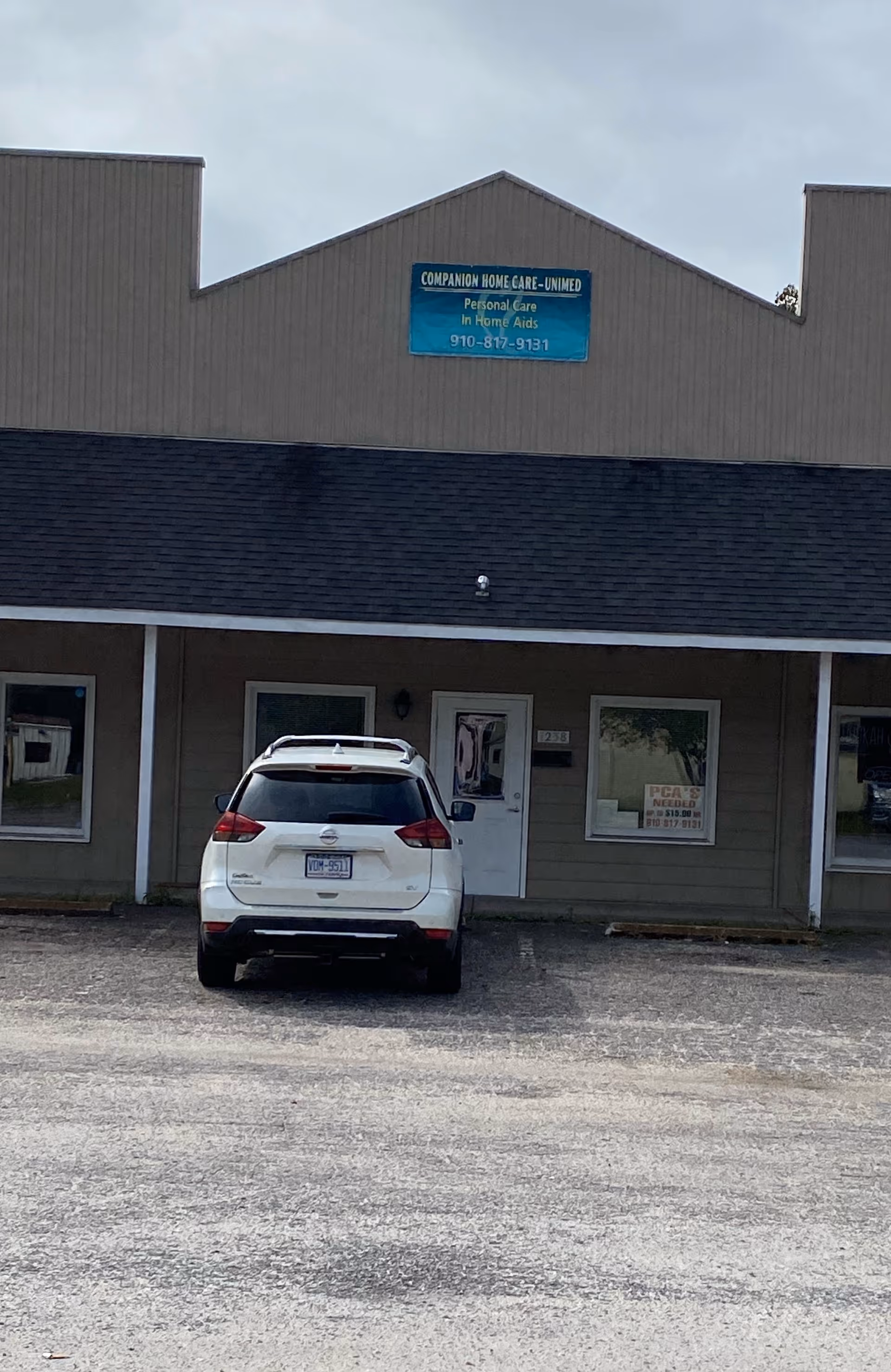 Front view of a Companion Home Care facility with a parked white SUV
