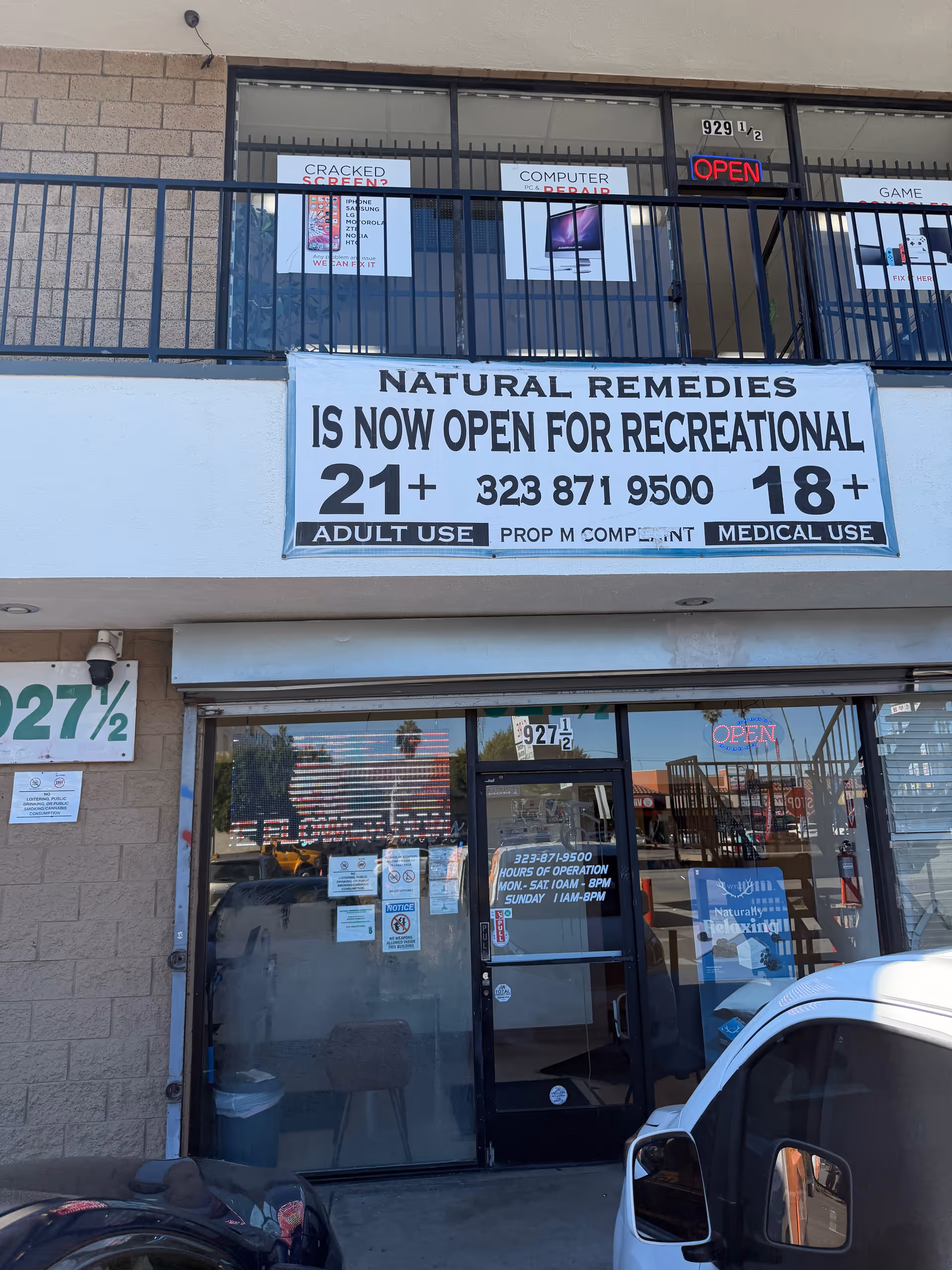 Exterior storefront with a large NATURAL REMEDIES banner, glass doors, and storefront signs.
