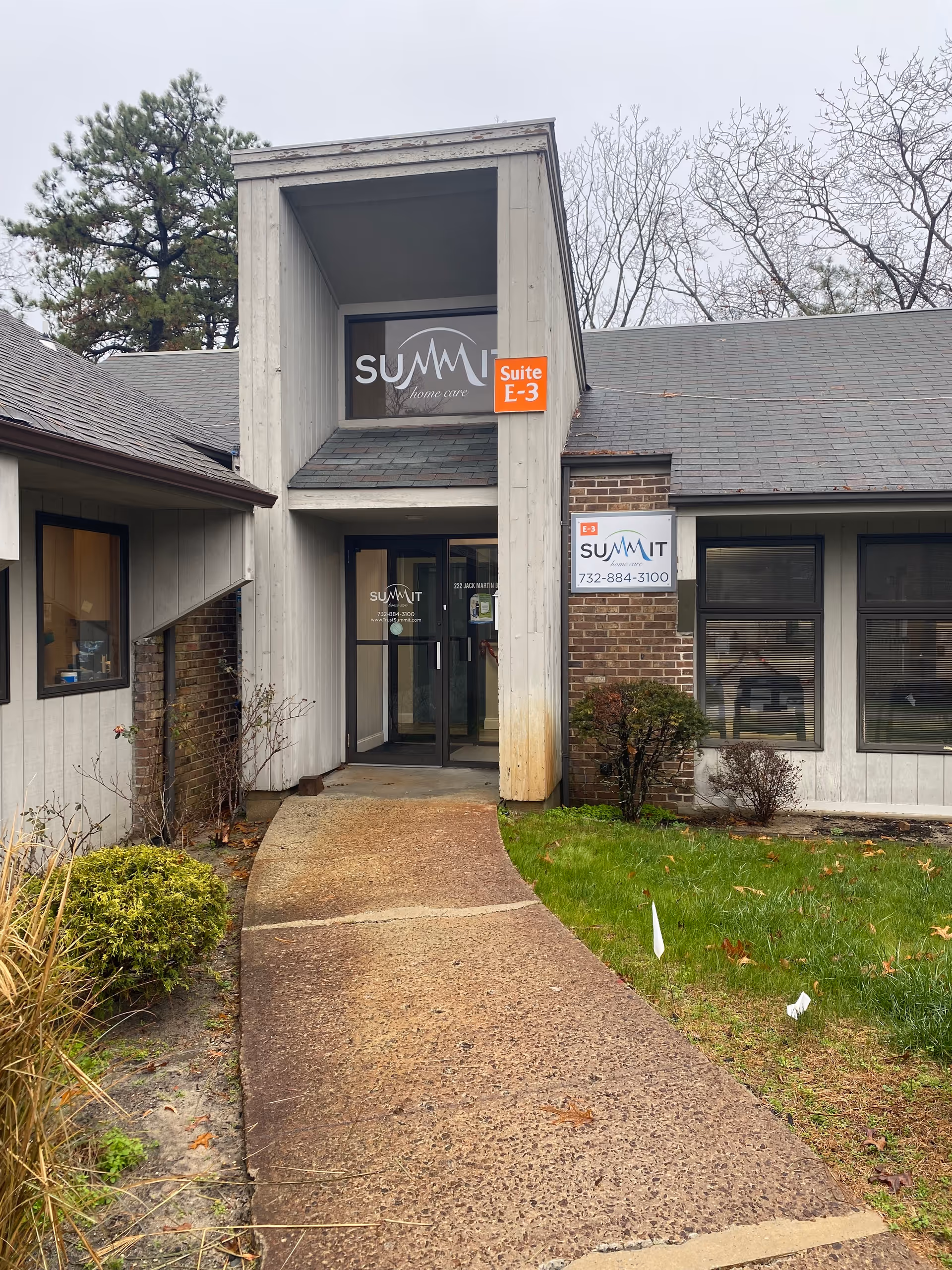 Exterior view of Summit Home Care entrance with walkway and signage.