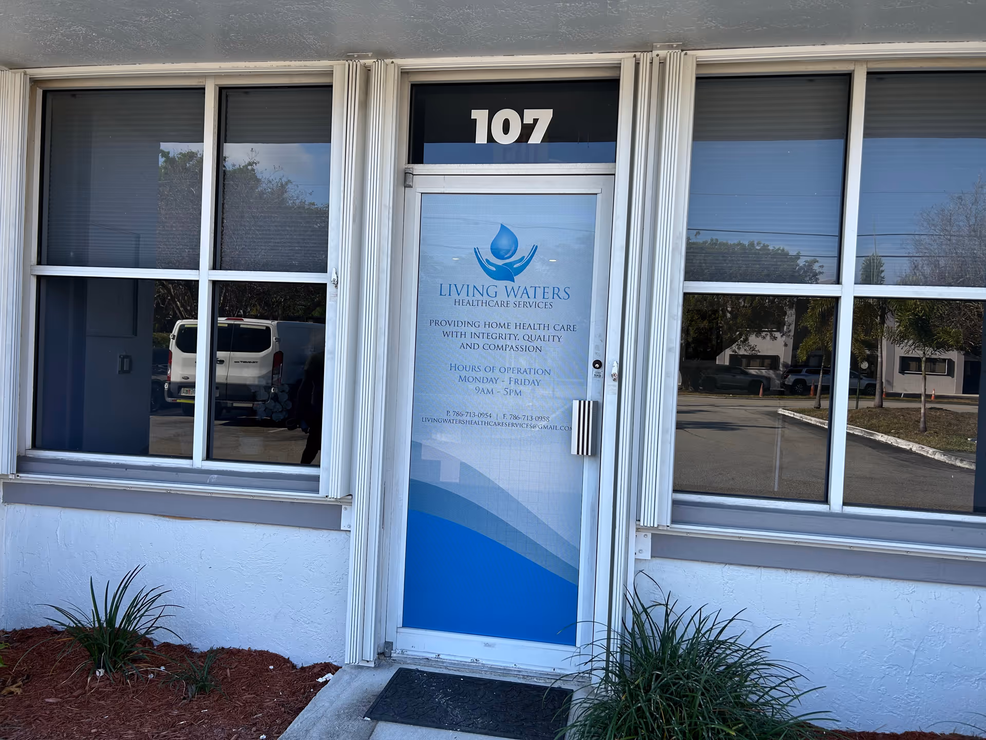 Front entrance of Living Waters Healthcare Services at 107, with glass door and large windows.