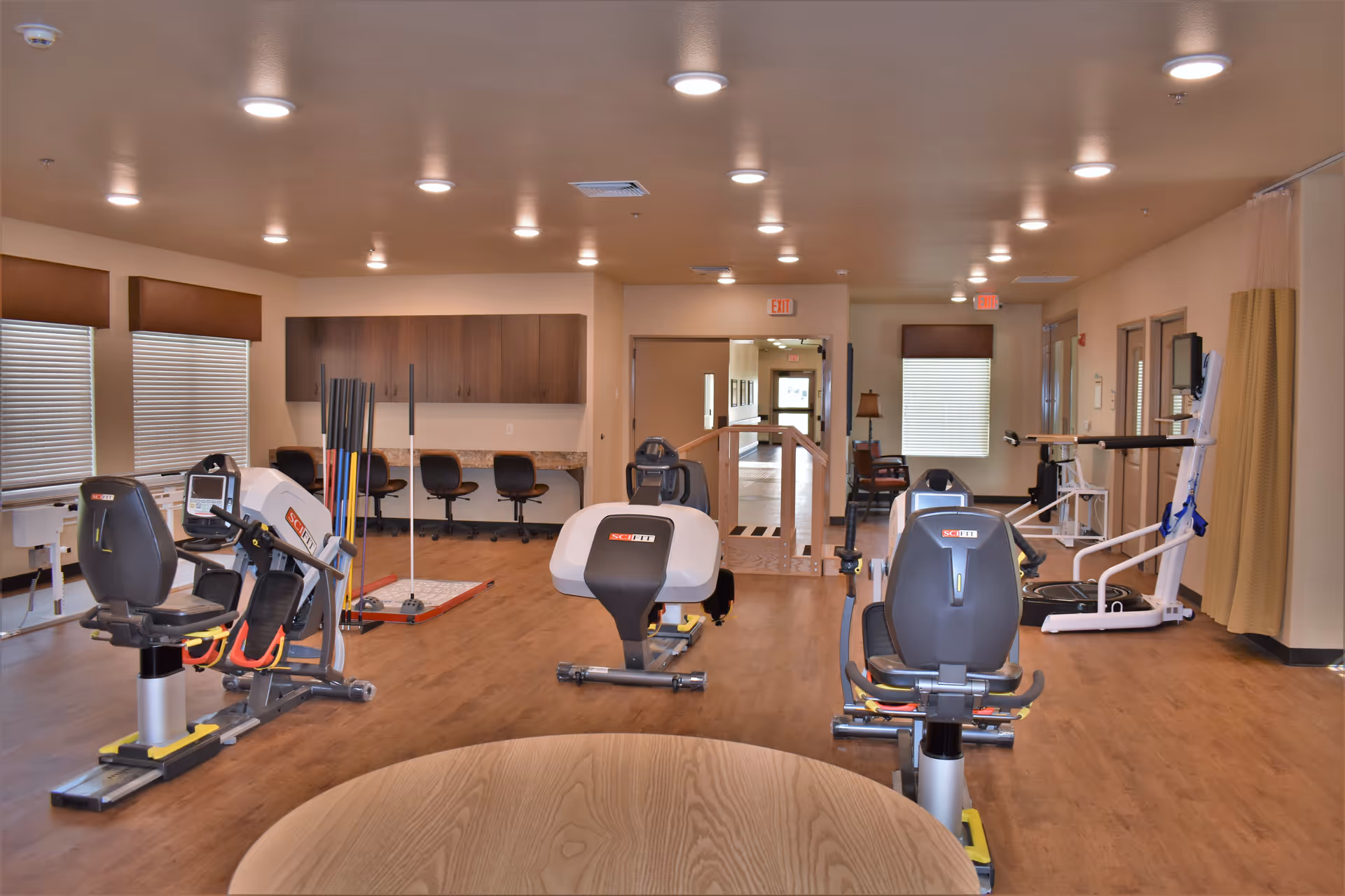 A spacious indoor gym in a senior facility with exercise equipment.