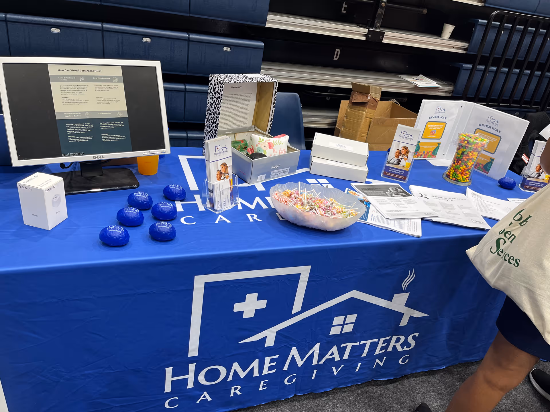 Promotional table for Home Matters Caregiving North Atlanta with brochures and candy at an indoor event