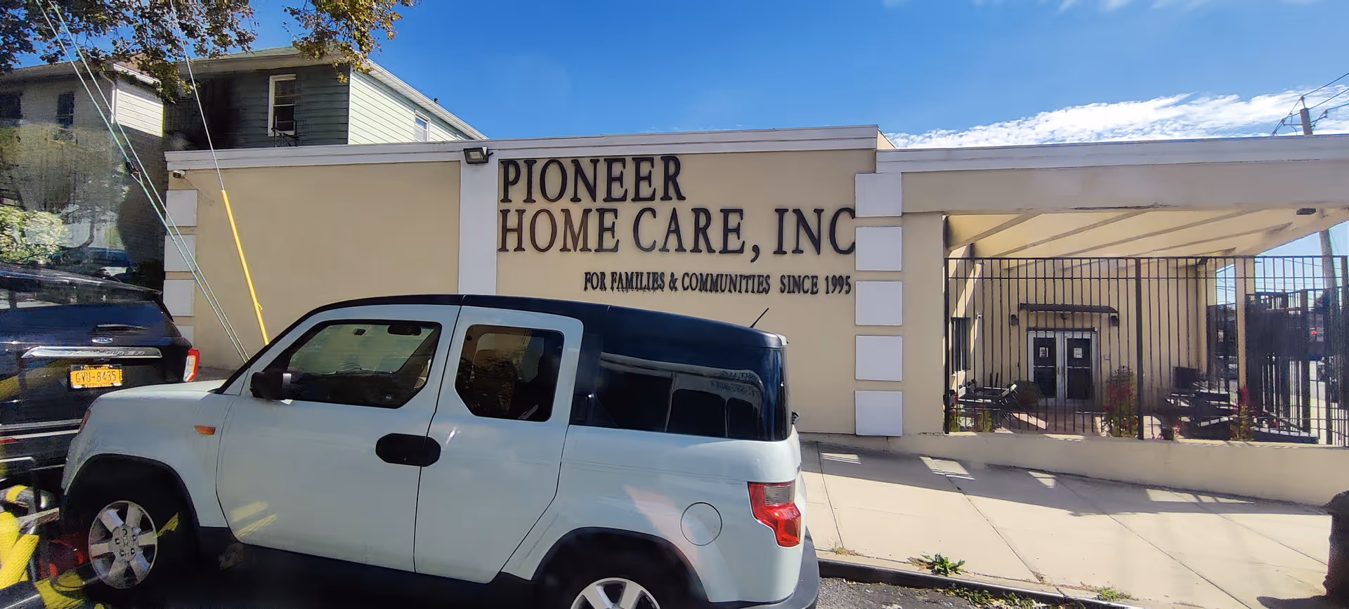 Front exterior of Pioneer Home Care, Inc. with a parked white SUV in front.