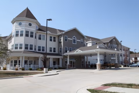 Multi-story Timberlake Supportive Living building with a covered entrance and parking lot.