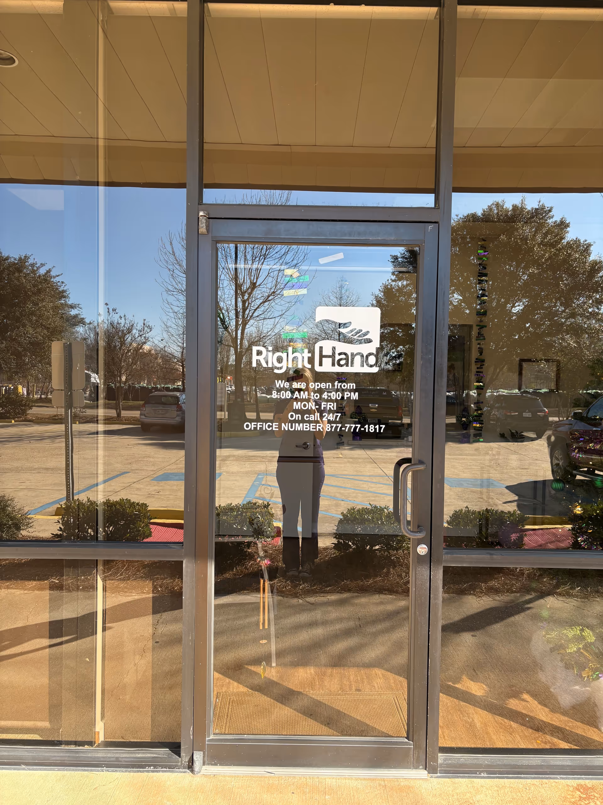 Glass storefront entrance with Right Hand Senior Care logo; reflection of parking lot