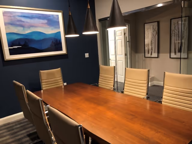 Wood conference table with beige chairs in a modern interior meeting room.