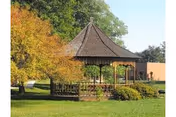 Outdoor gazebo in a courtyard with autumn trees at Wellsville Manor Care Center.