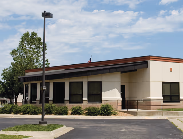 Exterior view of Coffey County Hospital senior living facility with windows and a parking lot