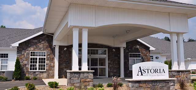 Front entrance of Astoria Skilled Nursing and Rehabilitation with stone exterior and canopy