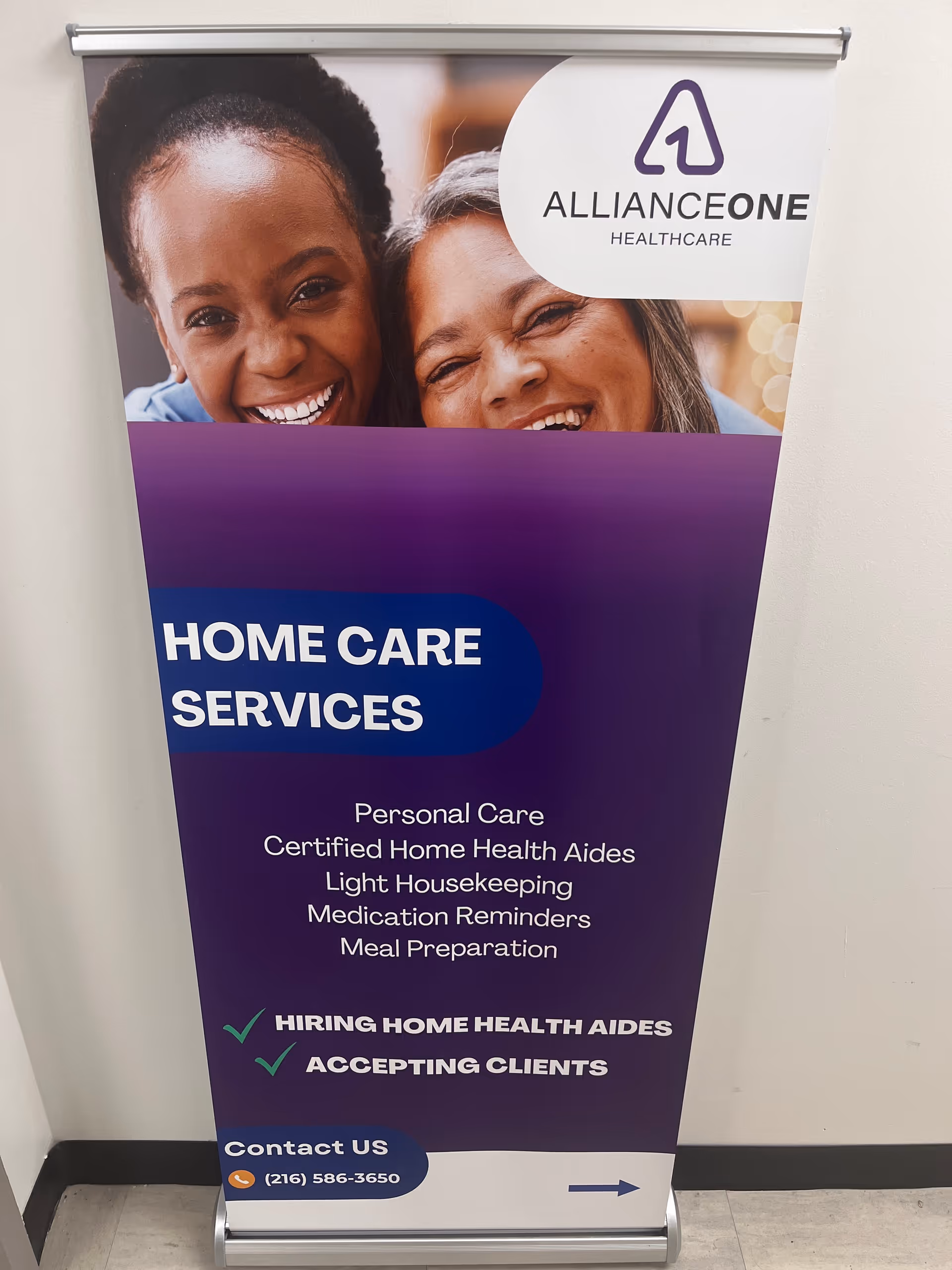 Indoor banner advertising home care services with smiling people.