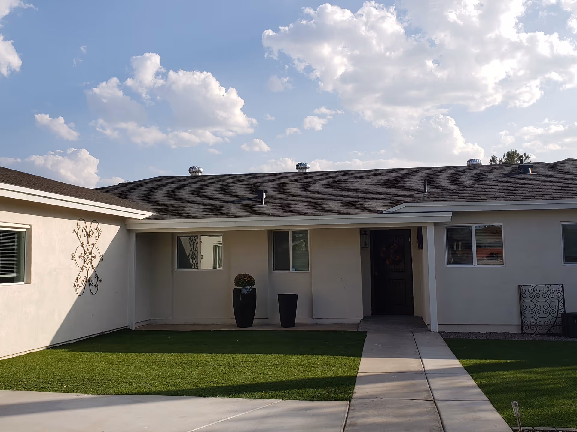 Front exterior of Sunrise Care Homes Paradise Valley with lawn and entrance.