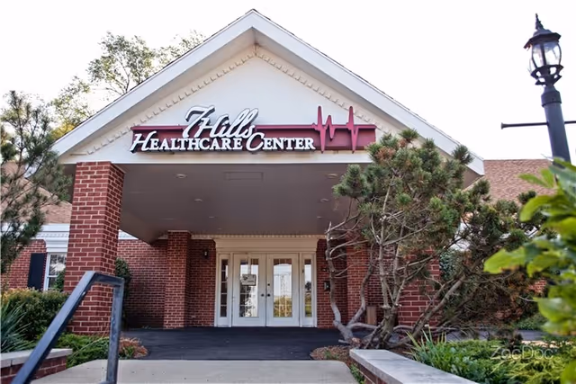 Front entrance of Fields Healthcare Center with brick columns and glass doors.