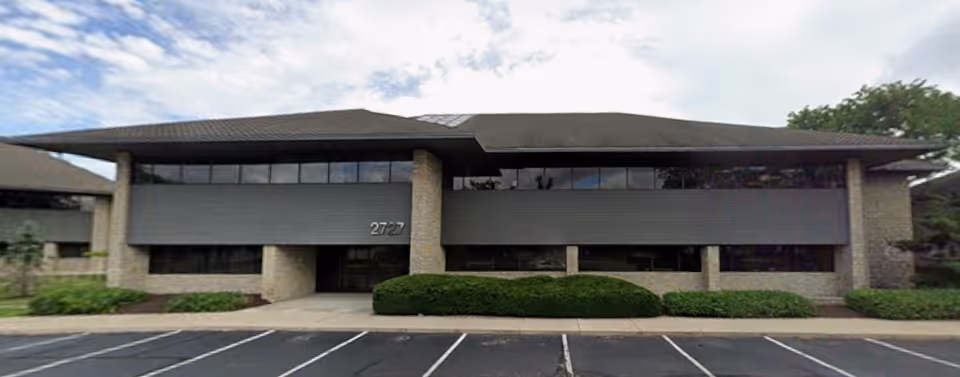 Exterior view of A Place At Home Dublin facility with a parking lot.