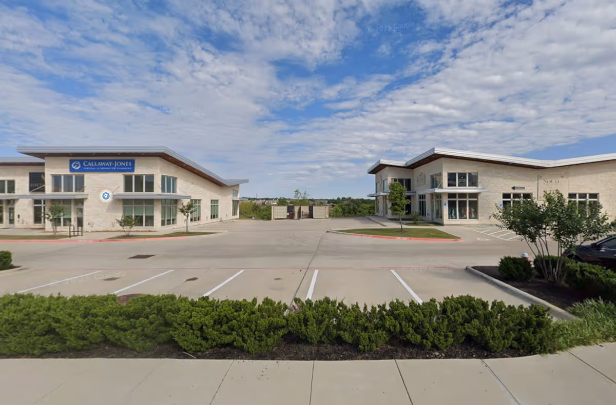 Exterior view of Century Home Care Partners facility with two modern buildings and a parking lot.