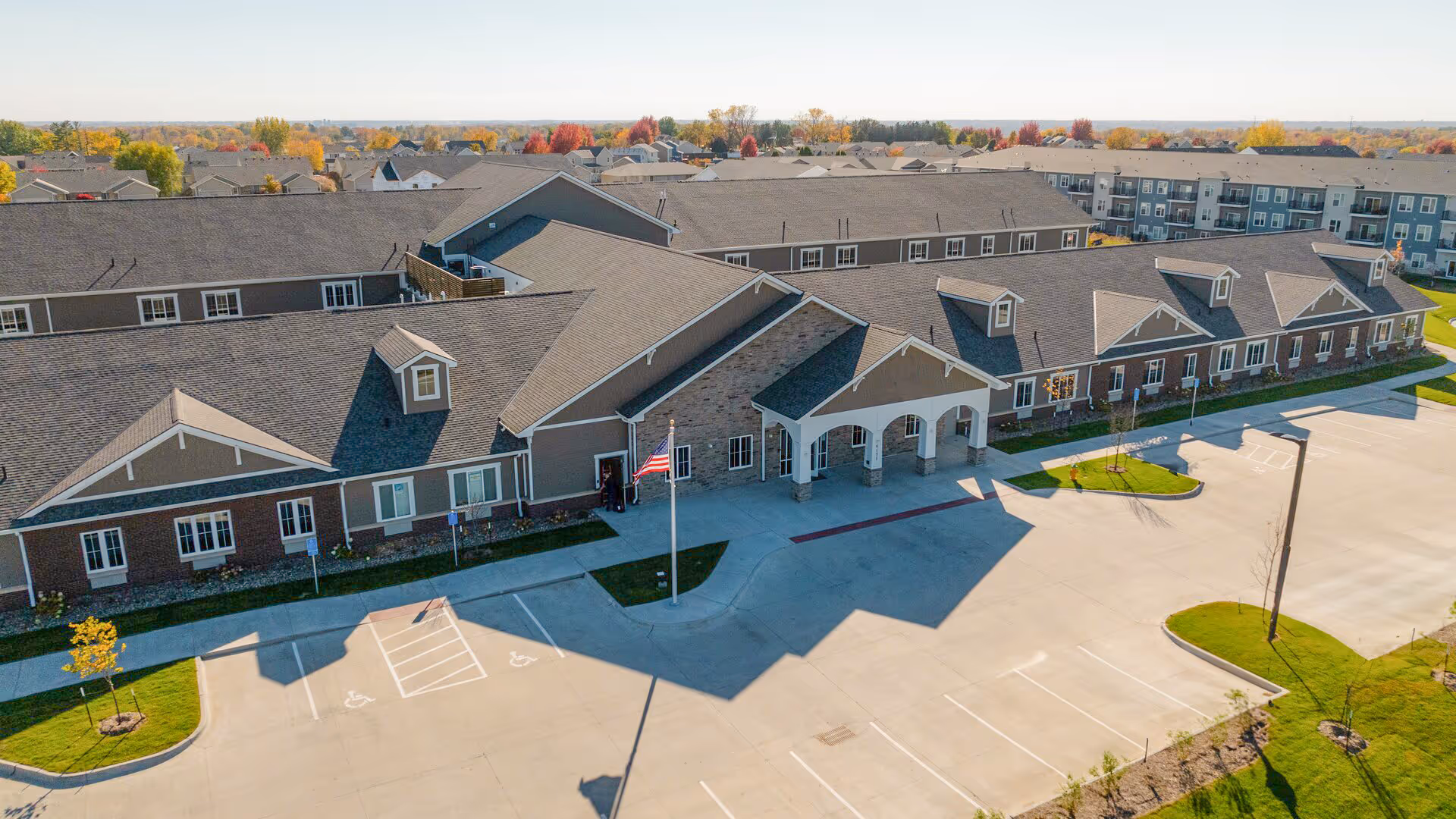 A large Edencrest at Pleasant Hill building with a covered entry and expansive parking lot.
