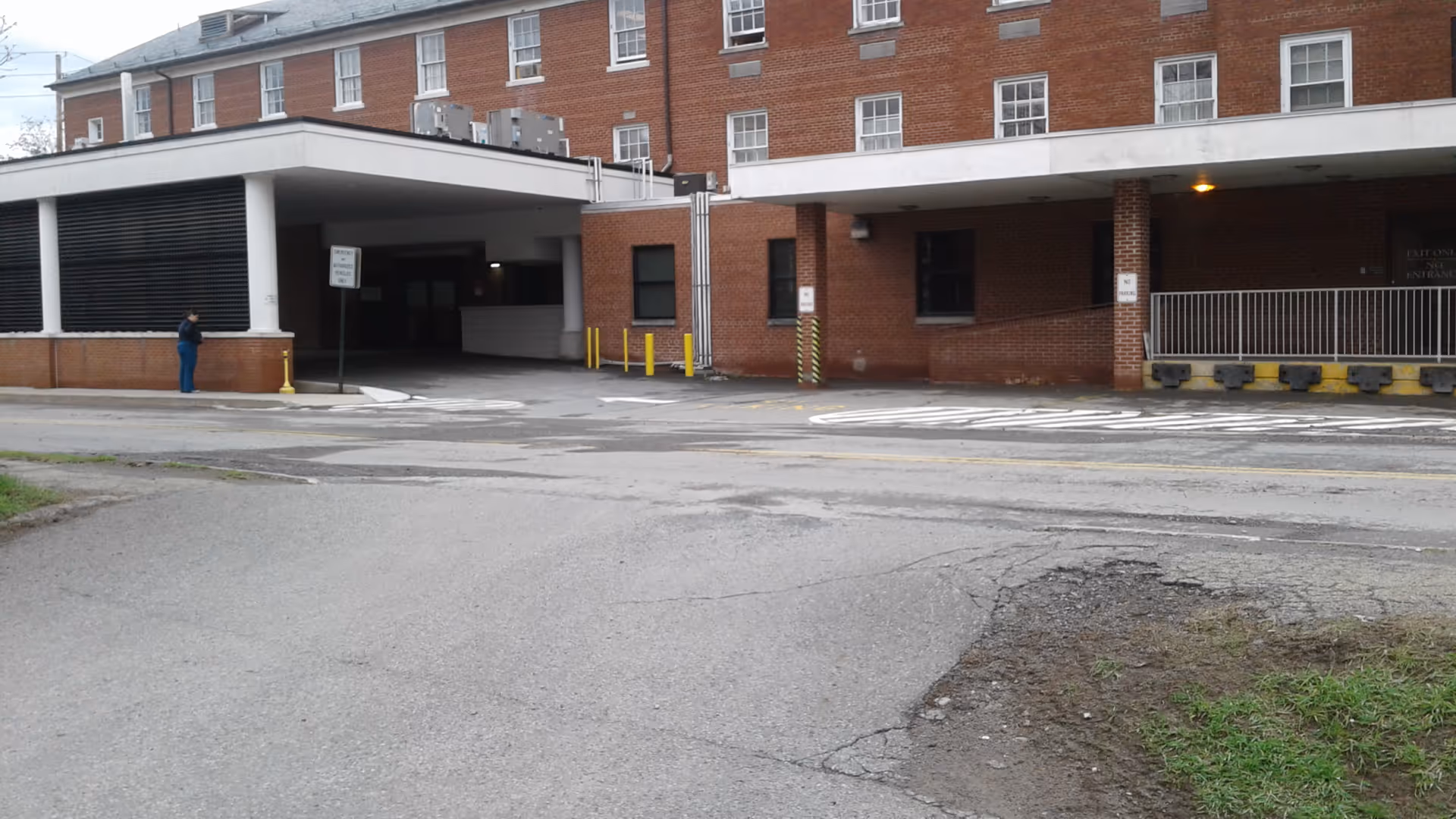Exterior view of Wayne Memorial Hospital with a brick facade, covered entrance, and driveway.