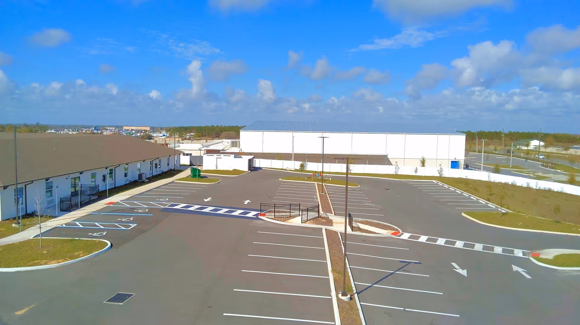 Aerial view of The Reserve at Davenport exterior with a large parking lot and white buildings.