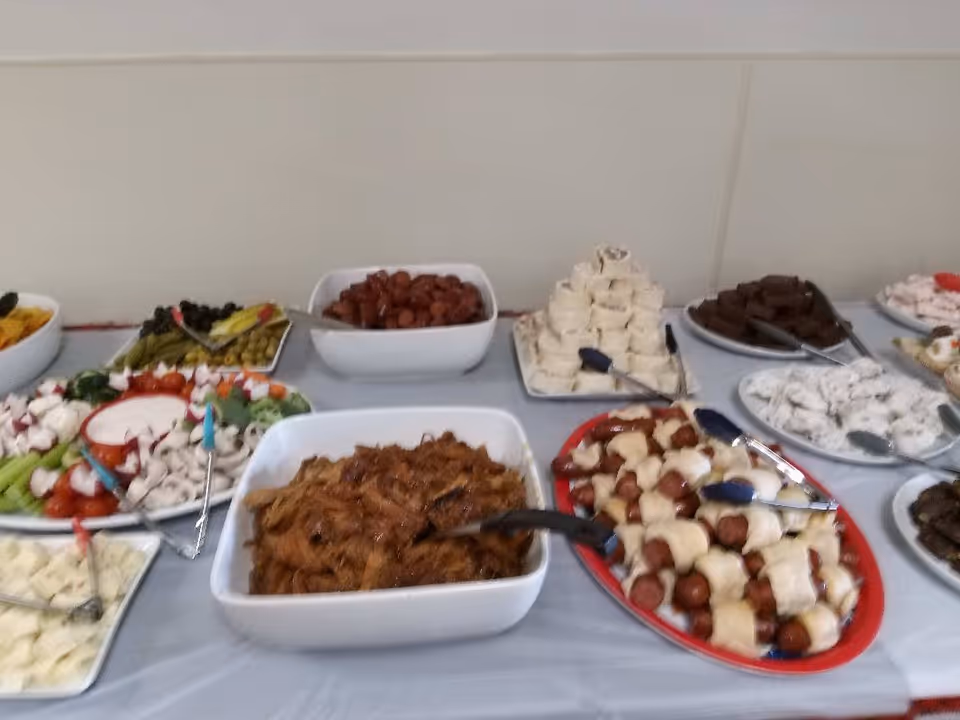 Buffet table with assorted desserts and dishes in a dining setting.