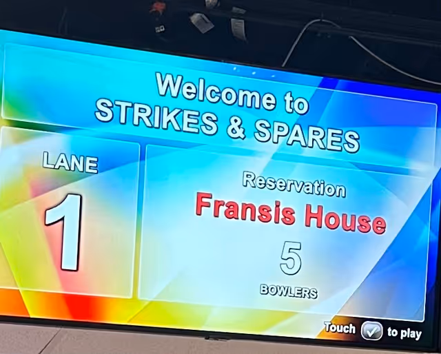 Indoor bowling screen: Welcome to Strikes & Spares, Lane 1, Francis House reservation for 5 bowlers.
