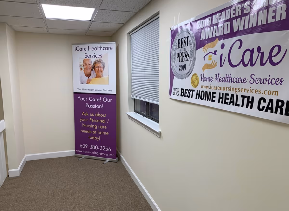 An interior hallway features two iCare banners advertising home healthcare services.