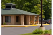 Small brick building with a covered entrance and a parked car in front.