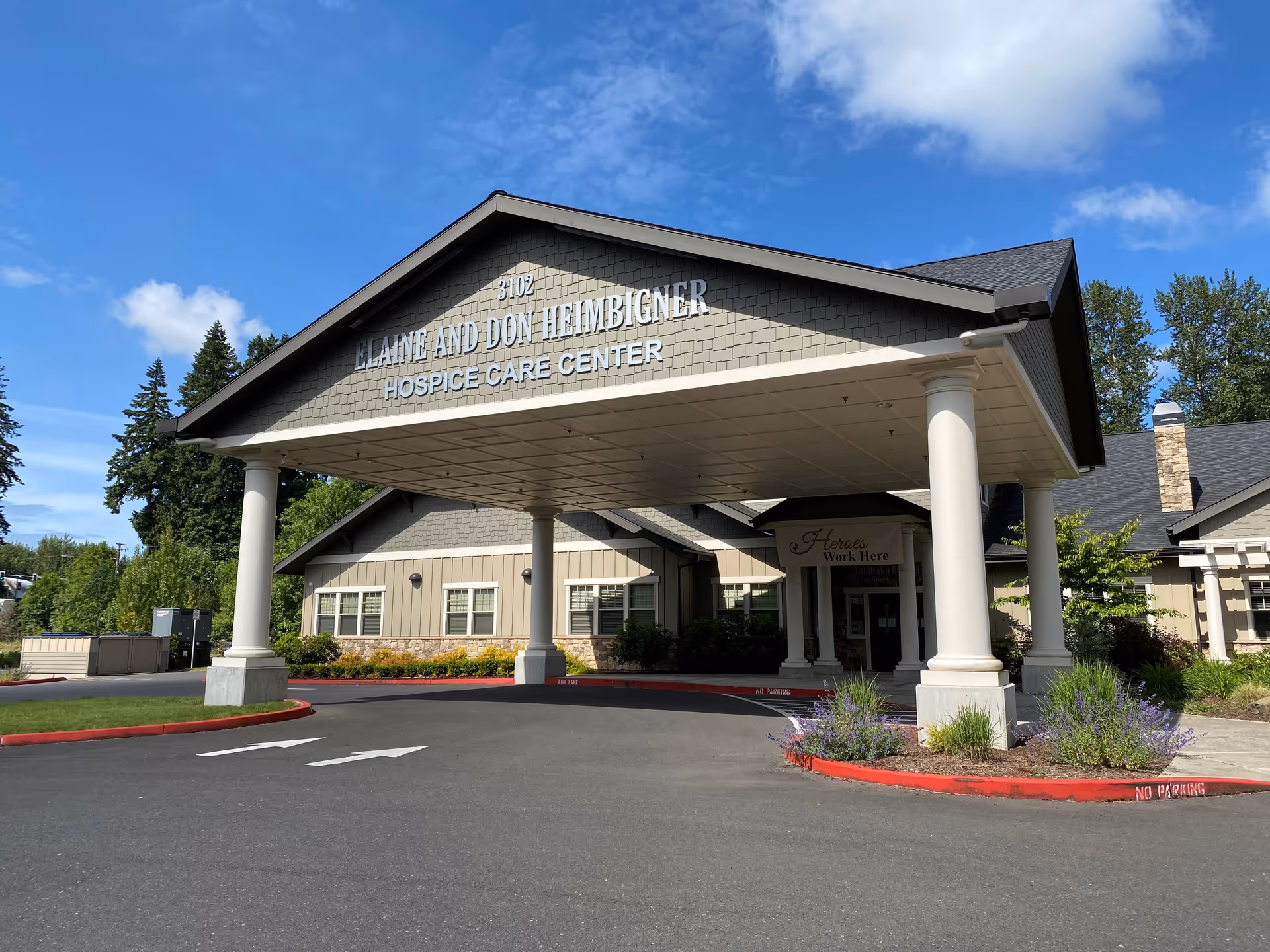 Front exterior of a hospice care center with a covered entrance and columns.