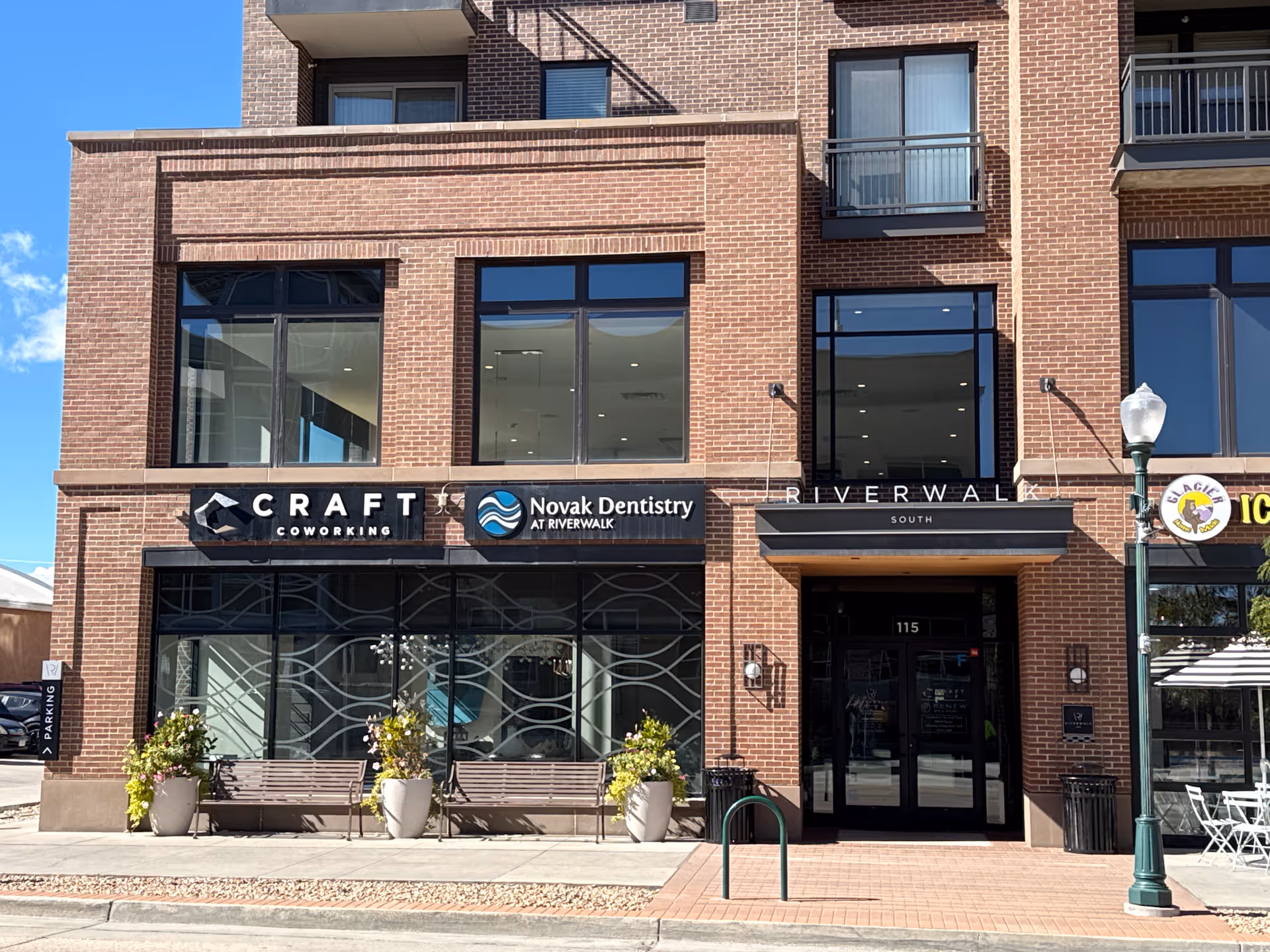 Brick building facade featuring Craft Coworking and Novak Dentistry storefronts.