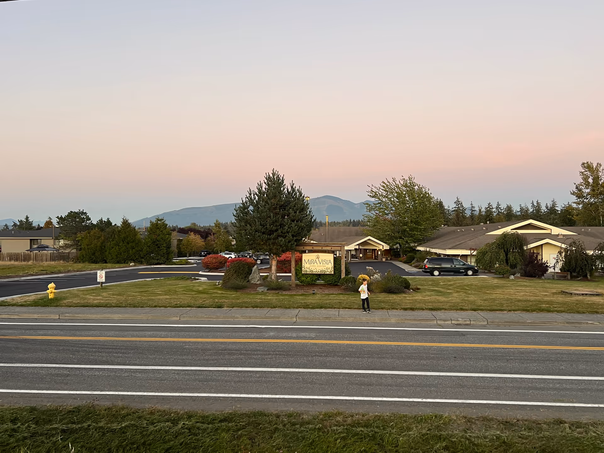 Exterior view of Mira Vista Care Center with sign, driveway, and landscaping.