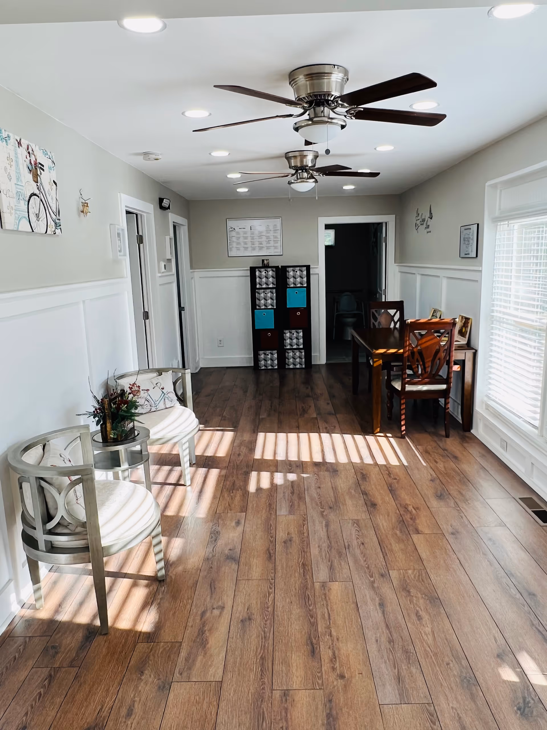 Interior common area with wood floors, seating, and a dining table.