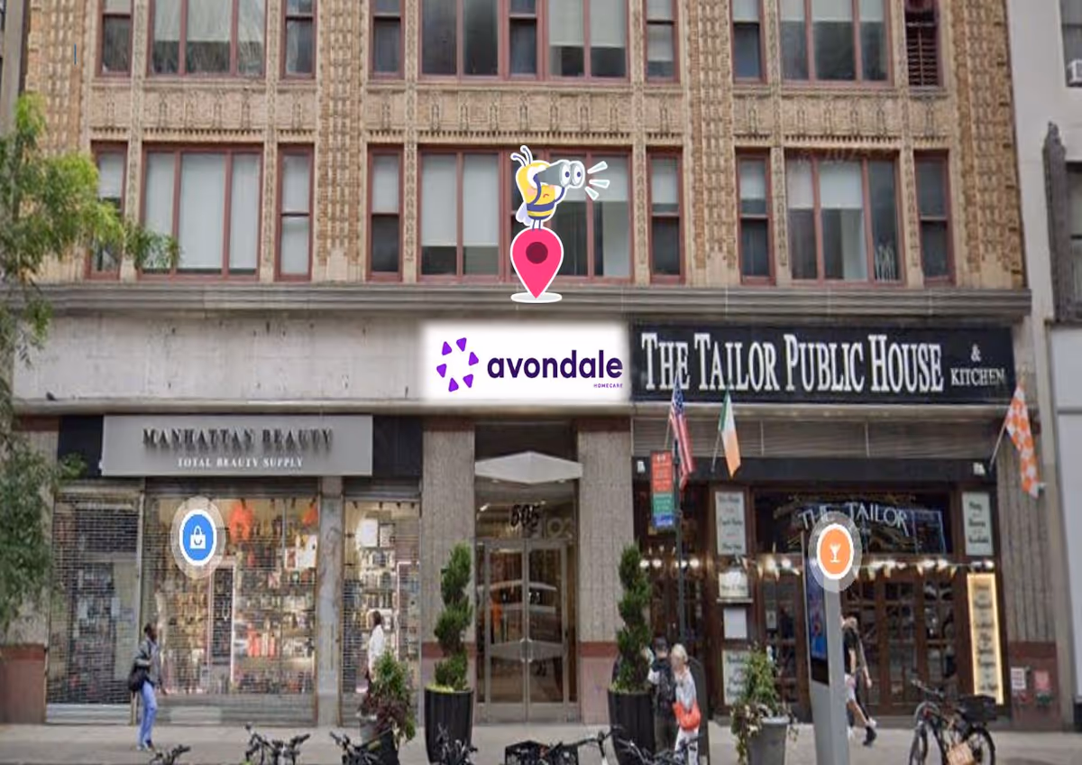 City street view of brick storefronts with an Avondale sign above the shops