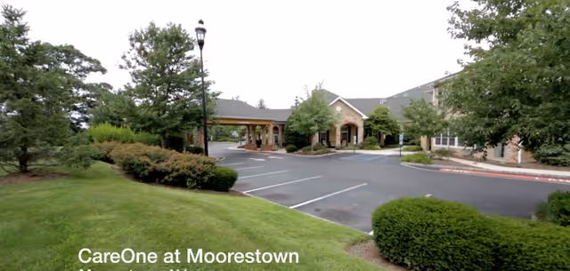 Exterior view of CareOne at Moorestown with entrance driveway and landscaping.