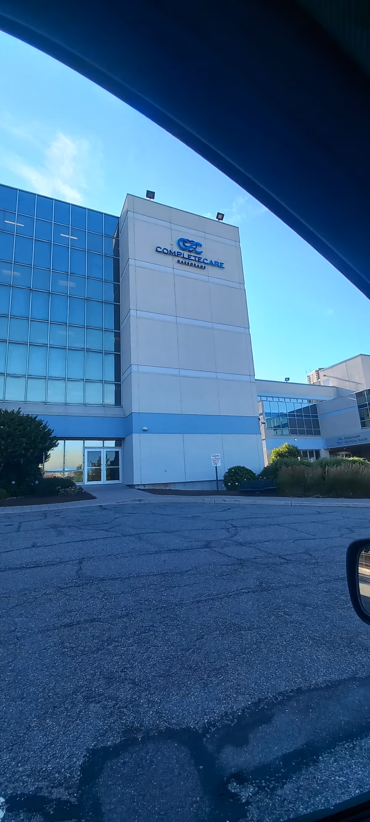 Modern building exterior with glass facade and a visible entrance.