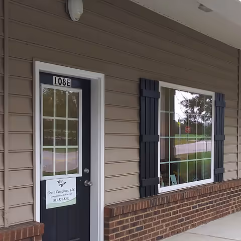 Exterior view of Grace Caregivers, LLC unit 108E with window and shutters.