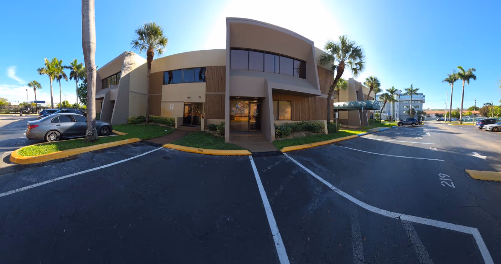 Exterior view of Diamond's Family Care Inc building with palm trees and a parking lot