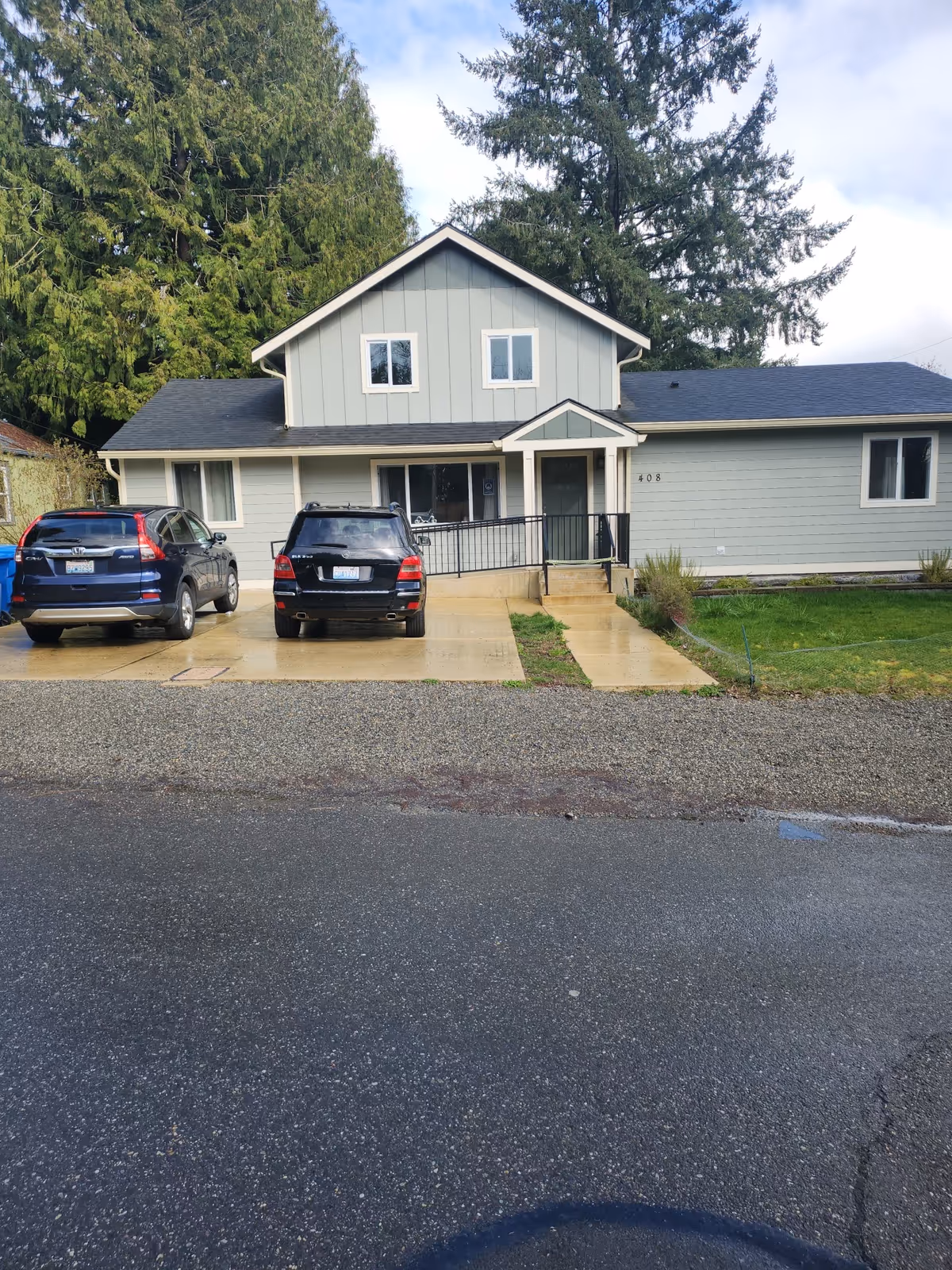 Front exterior view of Agano Adult Family Home with two parked cars.