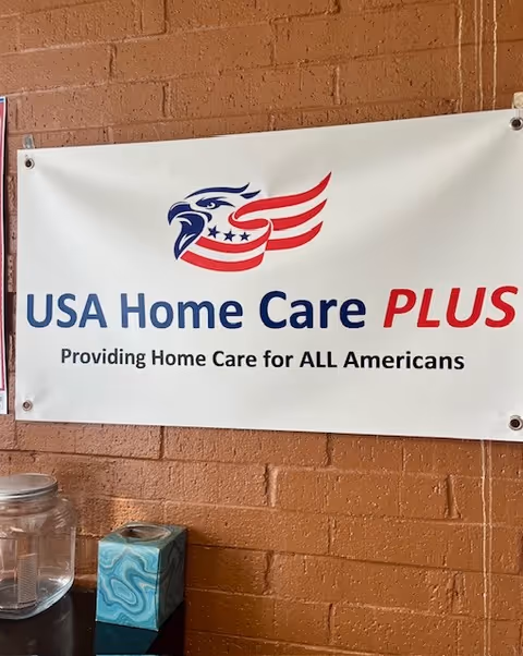 Sign on brick wall reads USA Home Care PLUS with an American eagle logo.
