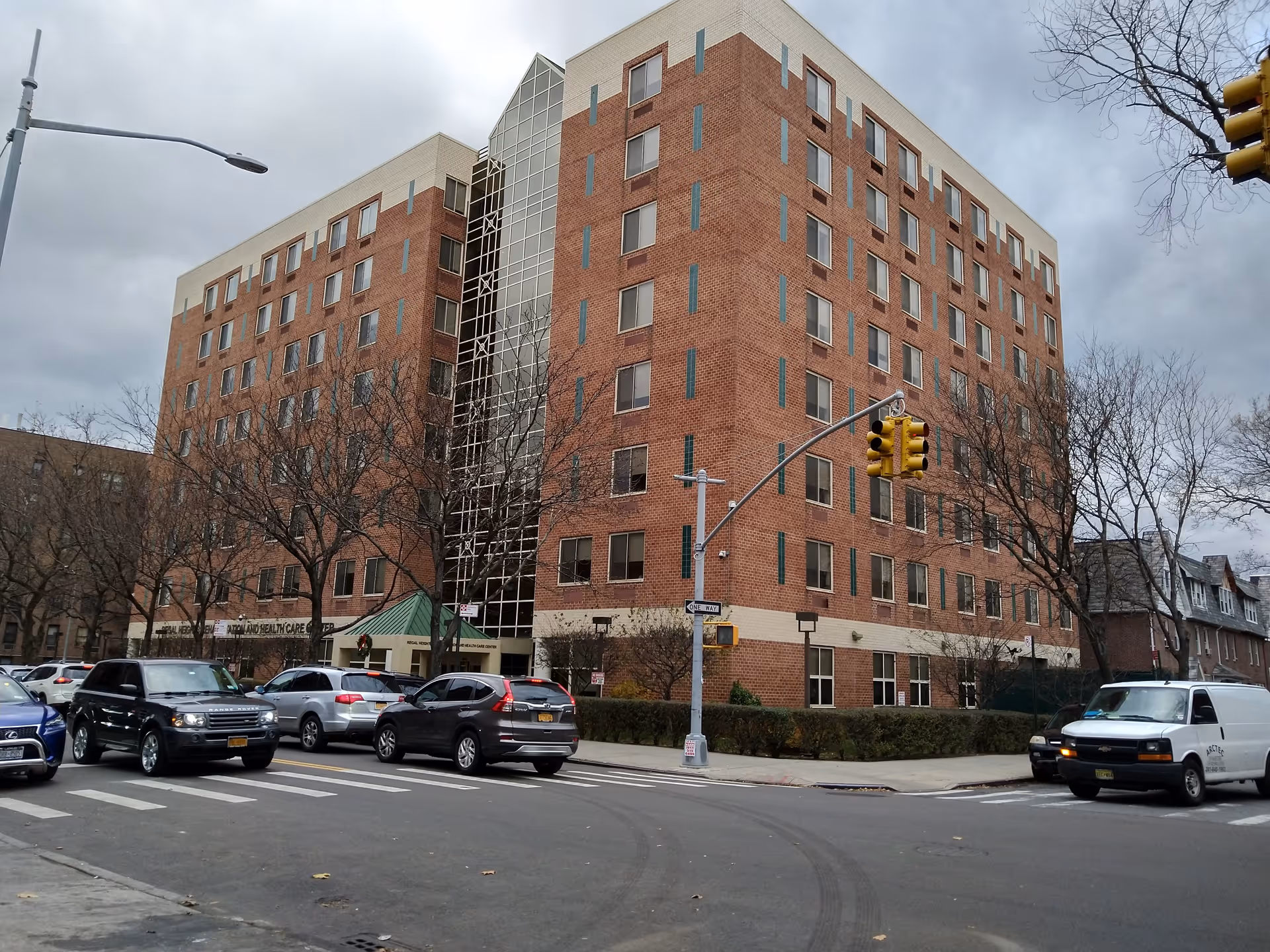 Regal Heights senior living building on a street corner with parked cars.